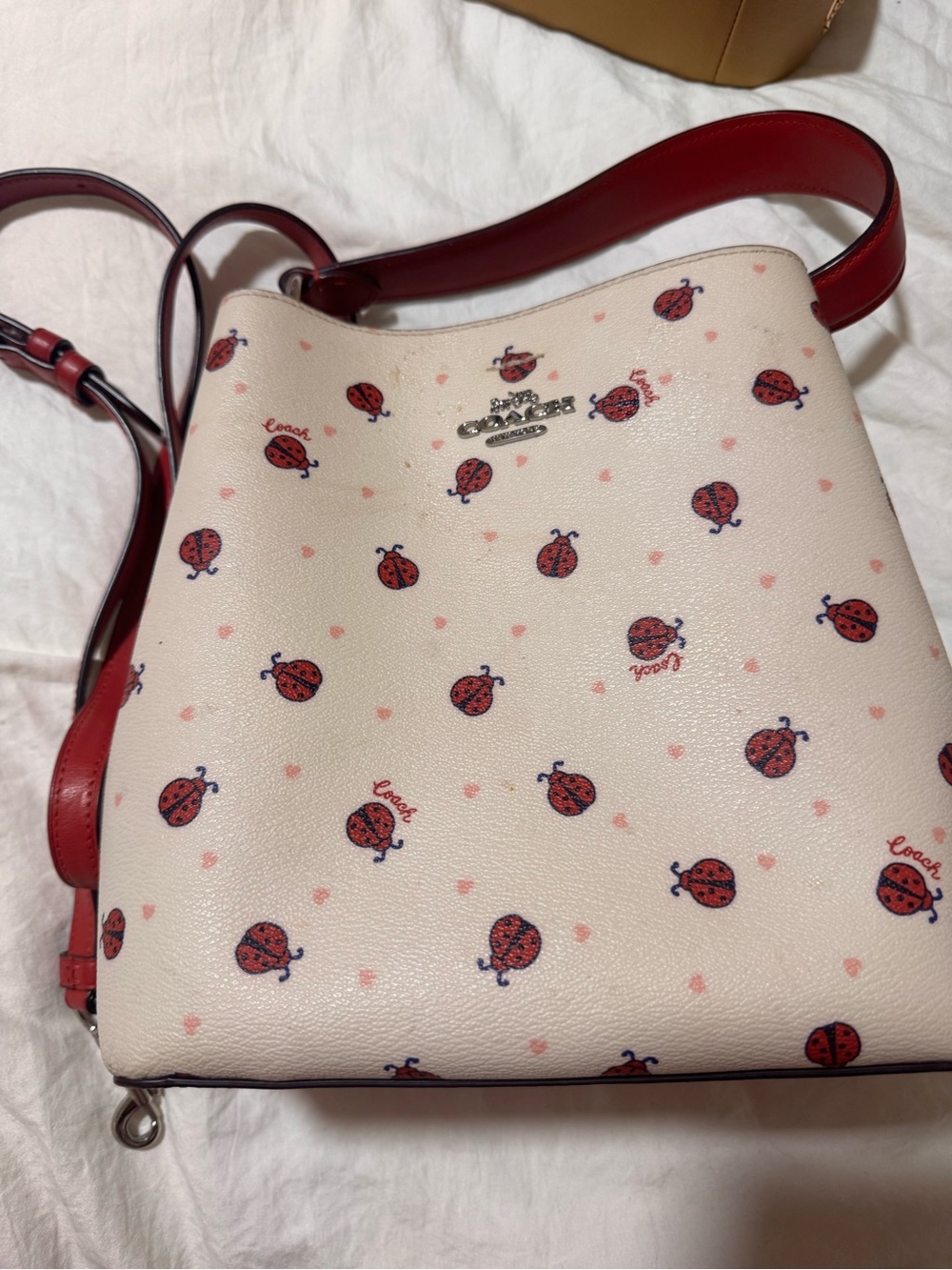 Coach Cream Pebbled Leather Crossbody with Red Ladybug Print